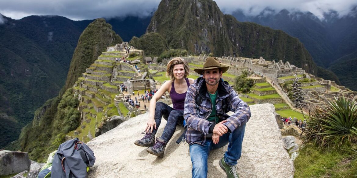 Couple resting at Machu Picchu after a luxury lodge-to-lodge hiking tour